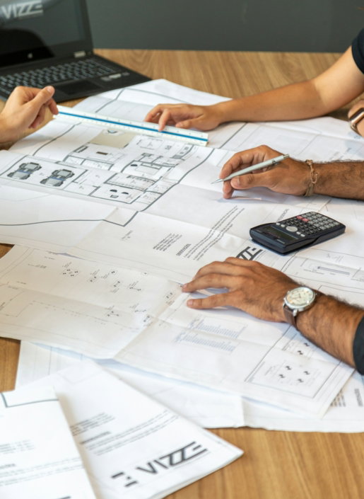 people-reviewing-architectural-blueprints-on-desk.jpg people reviewing architectural blueprints on desk